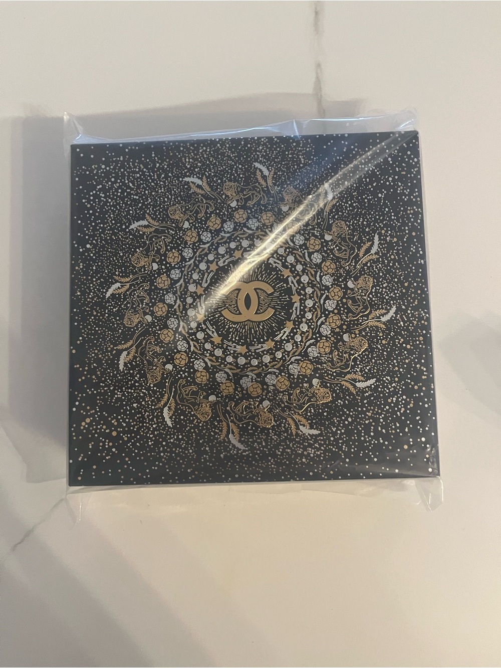 Chanel circular makeup bag in original box.